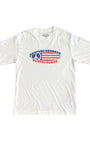 Youth-size white T-shirt with Surfing Cowboys red, white, and blue peace flag surfboard graphic on front.