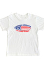 Toddler-size white T-shirt with Surfing Cowboys red, white, and blue peace flag surfboard graphic on front.