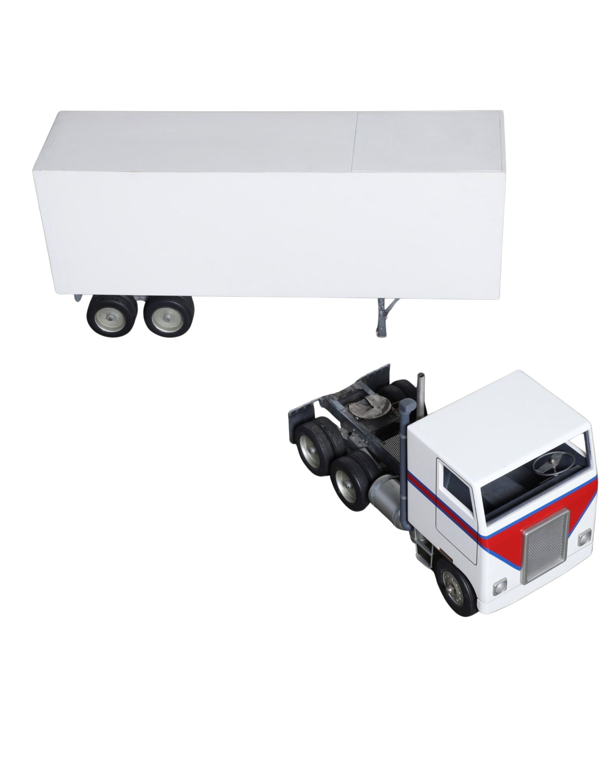 Handcrafted 1970s semi-truck model with wood body, metal parts, and rubber tires.