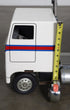 Handcrafted 1970s semi-truck model with wood body, metal parts, and rubber tires.