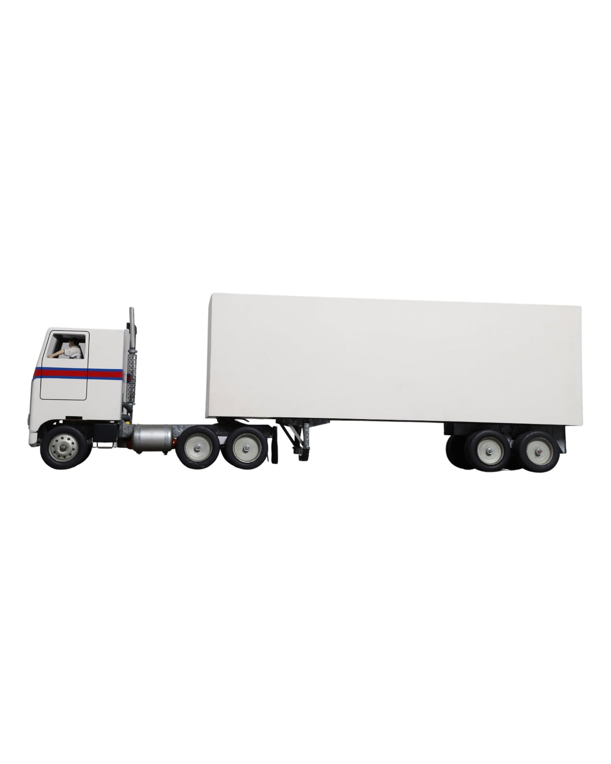 Handcrafted 1970s semi-truck model with wood body, metal parts, and rubber tires.