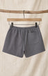 Back of Surfing Cowboys Relaxed Shorts in Loopback Cotton – Dove Grey on hanger in front of canvas background
