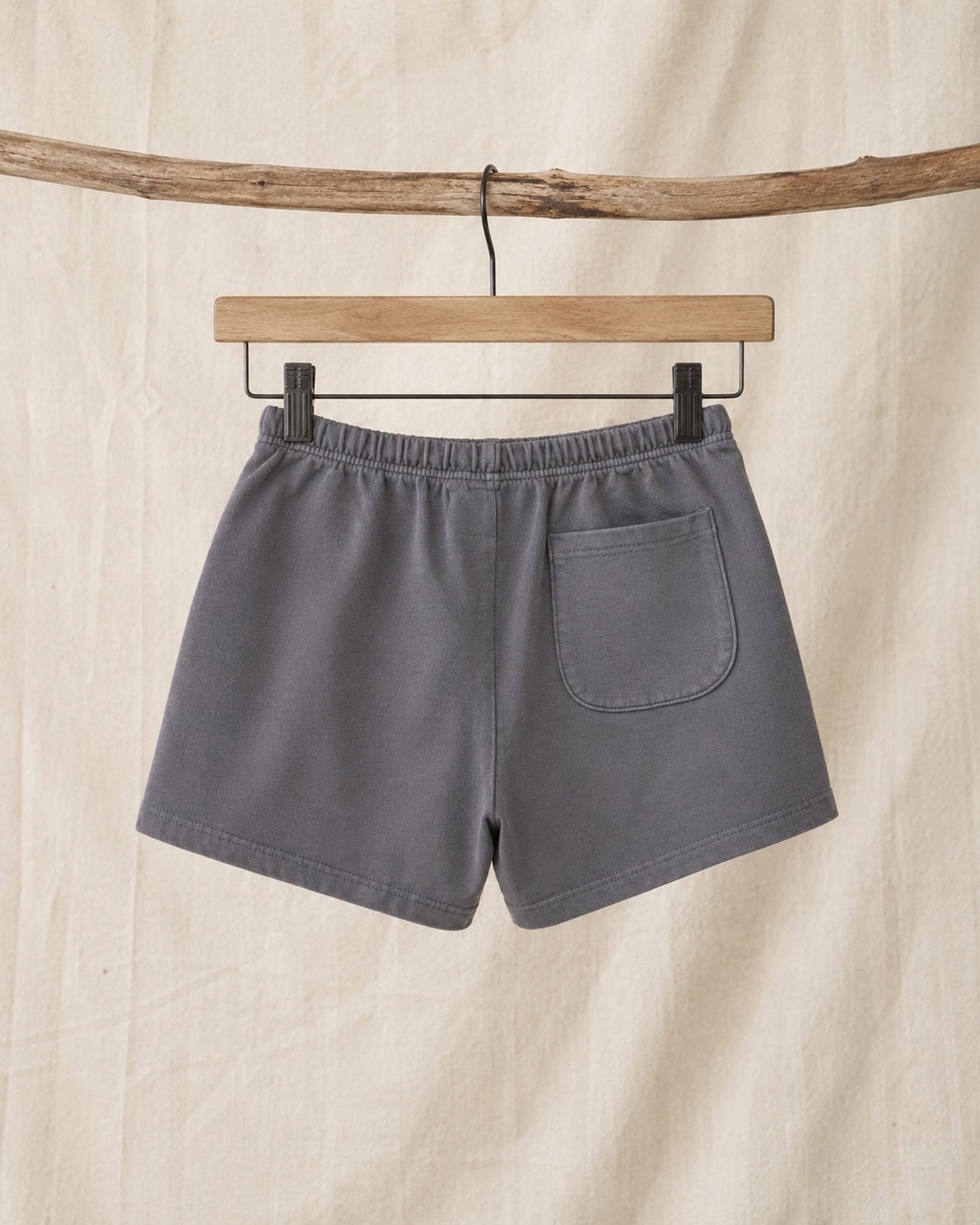 Back of Surfing Cowboys Relaxed Shorts in Loopback Cotton – Dove Grey on hanger in front of canvas background