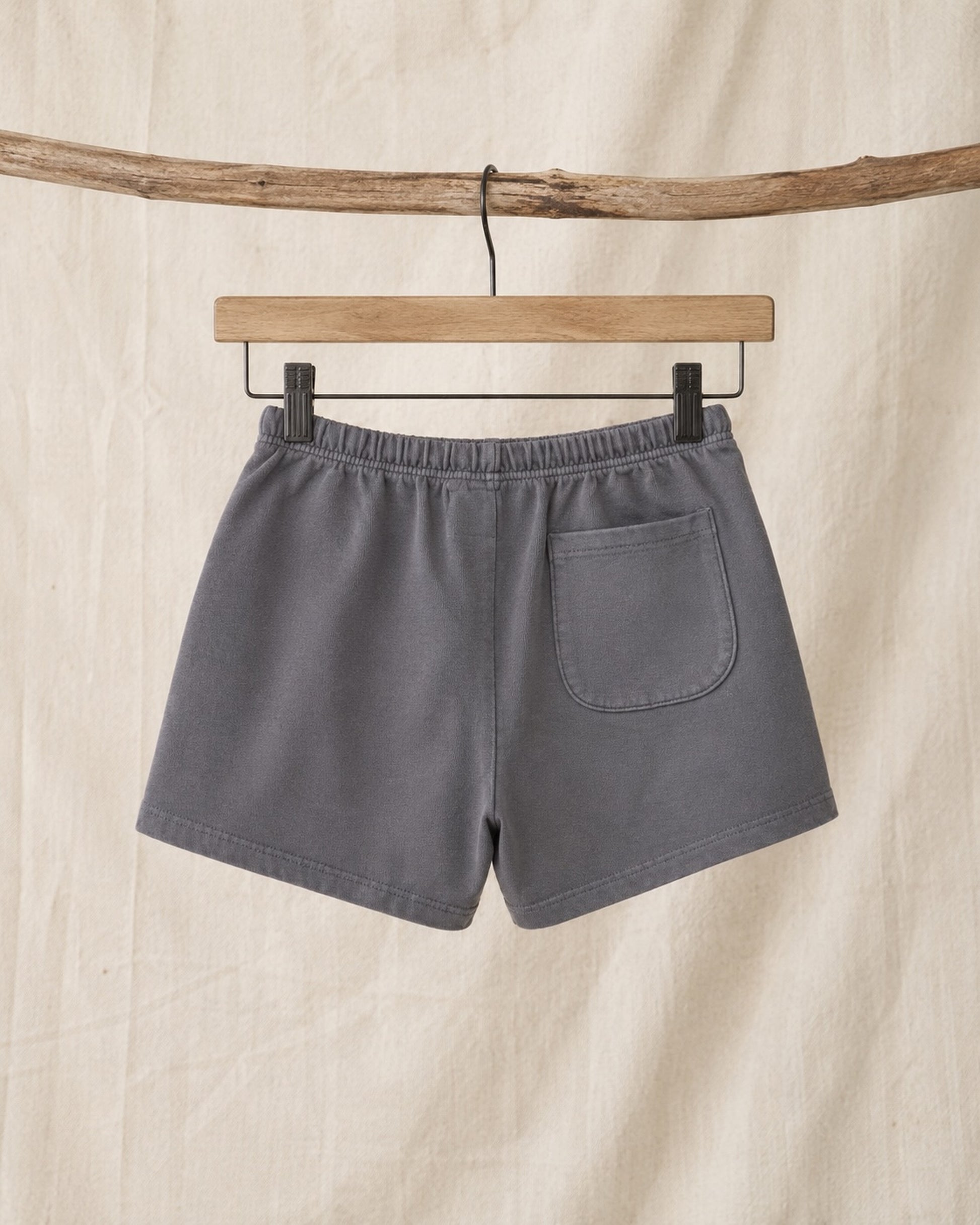 Back of Surfing Cowboys Relaxed Shorts in Loopback Cotton – Dove Grey on hanger in front of canvas background