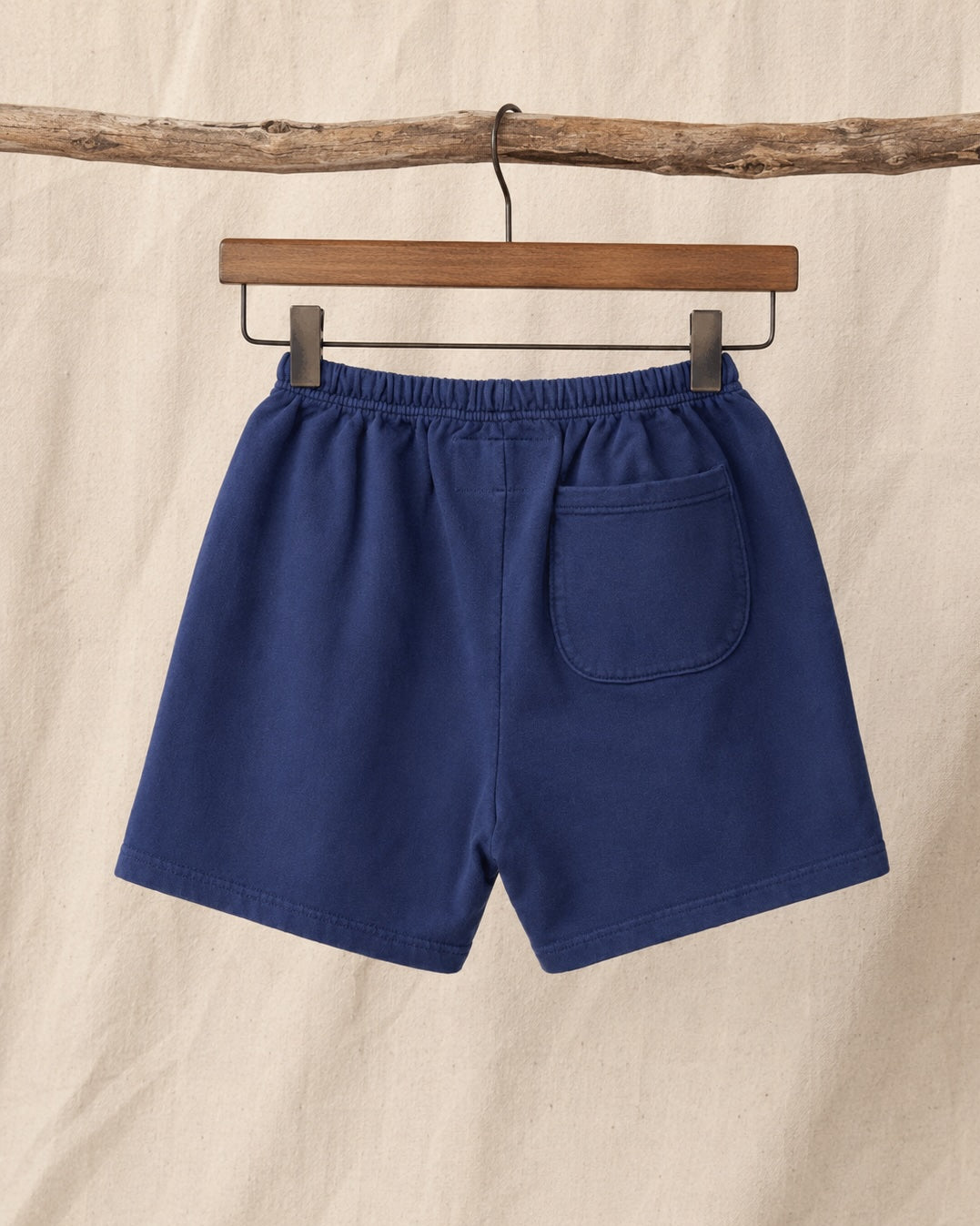 Back view of Surfing Cowboys Relaxed Shorts in Washed Navy loopback cotton with elastic waist and back patch pocket.