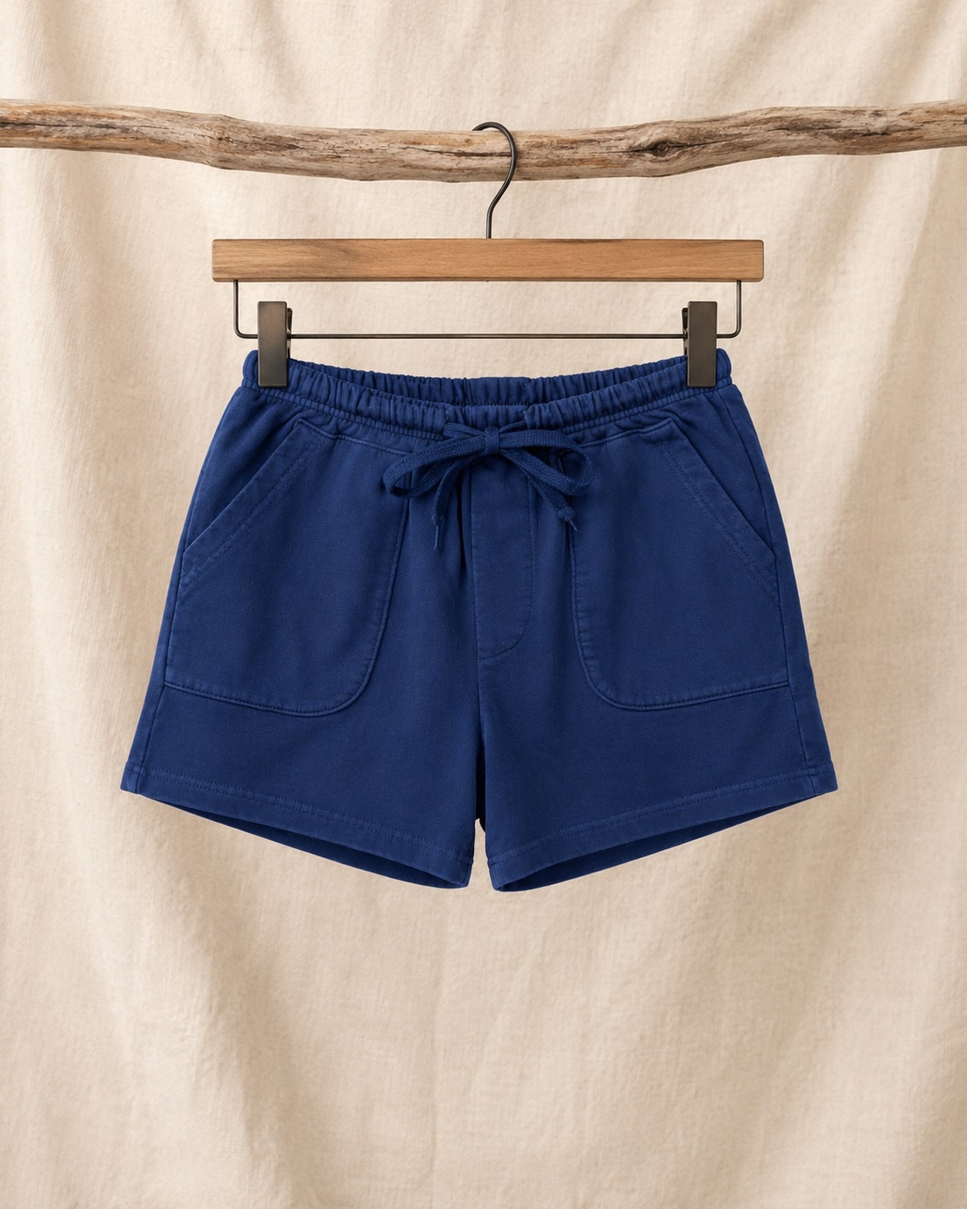 Front of Surfing Cowboys Relaxed Shorts in Loopback Cotton – Washed Navy on hanger in front of canvas background.