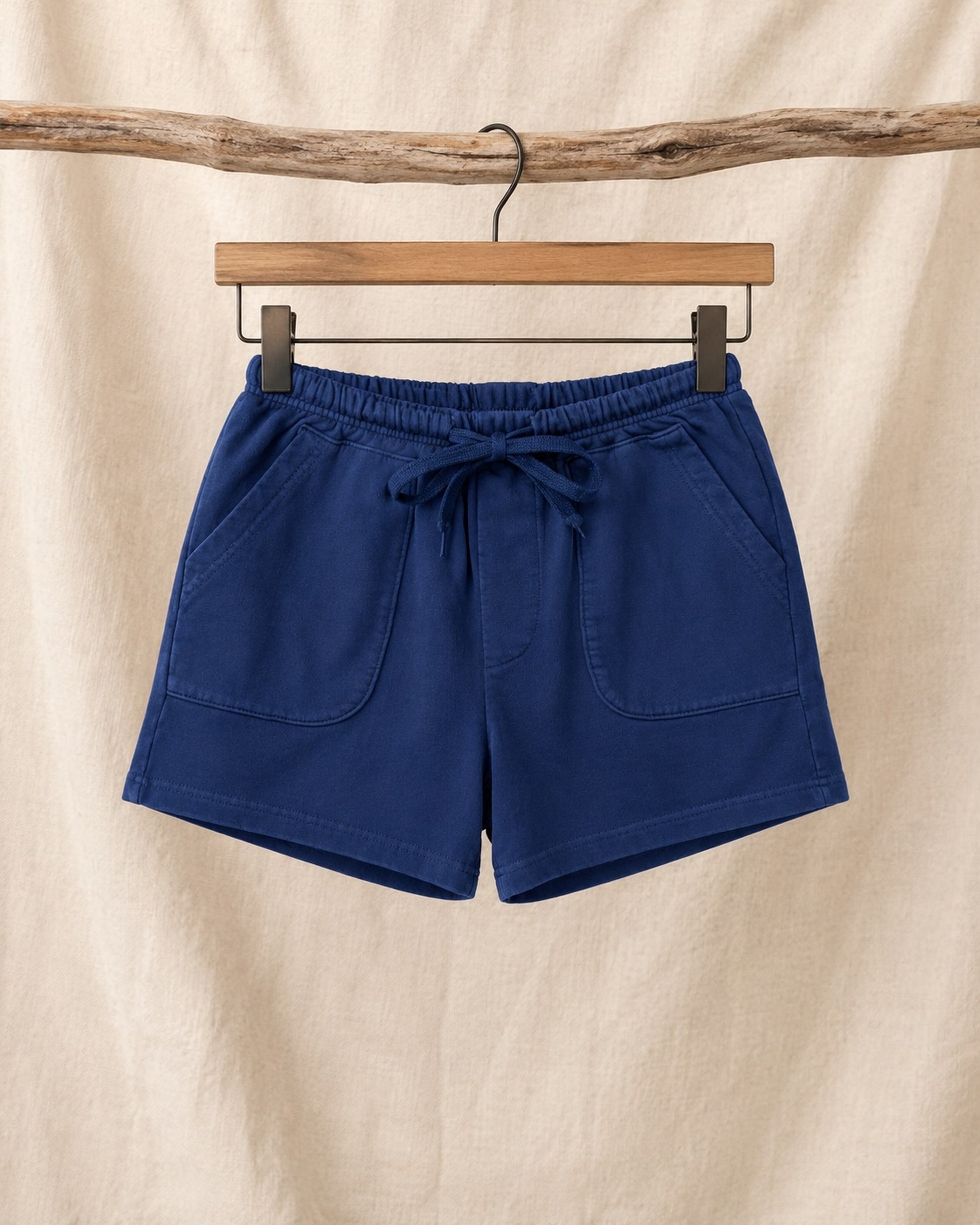 Front of Surfing Cowboys Relaxed Shorts in Loopback Cotton – Washed Navy on hanger in front of canvas background.
