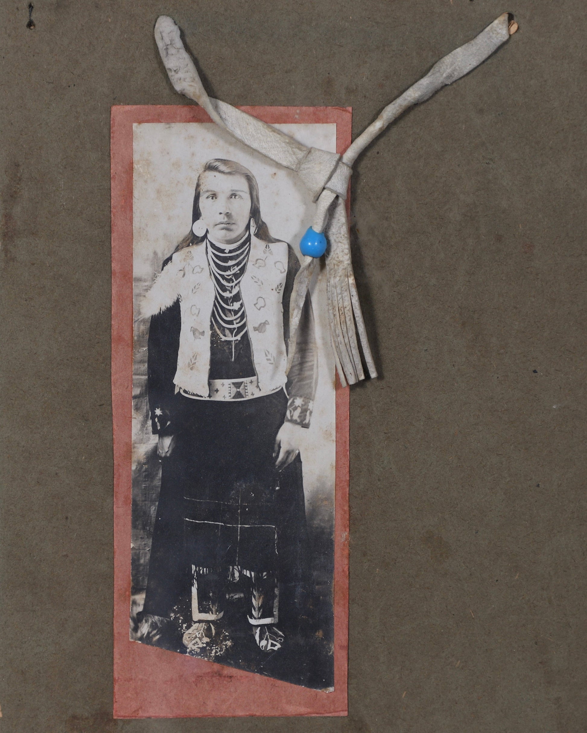 Detail of 19th-century photographic portrait showing an unidentified Native American adult in traditional dress.